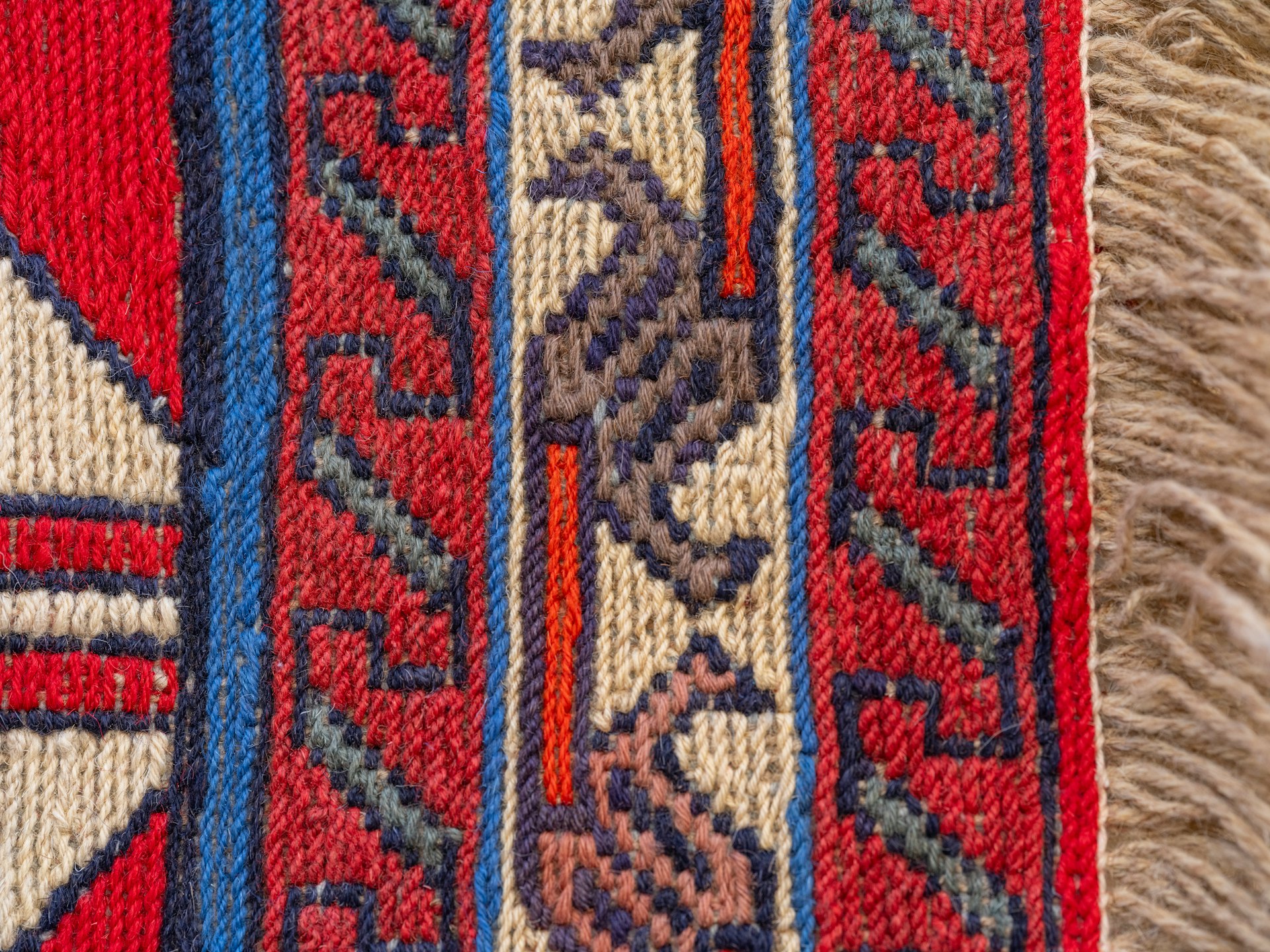 A close up of a red and blue rug